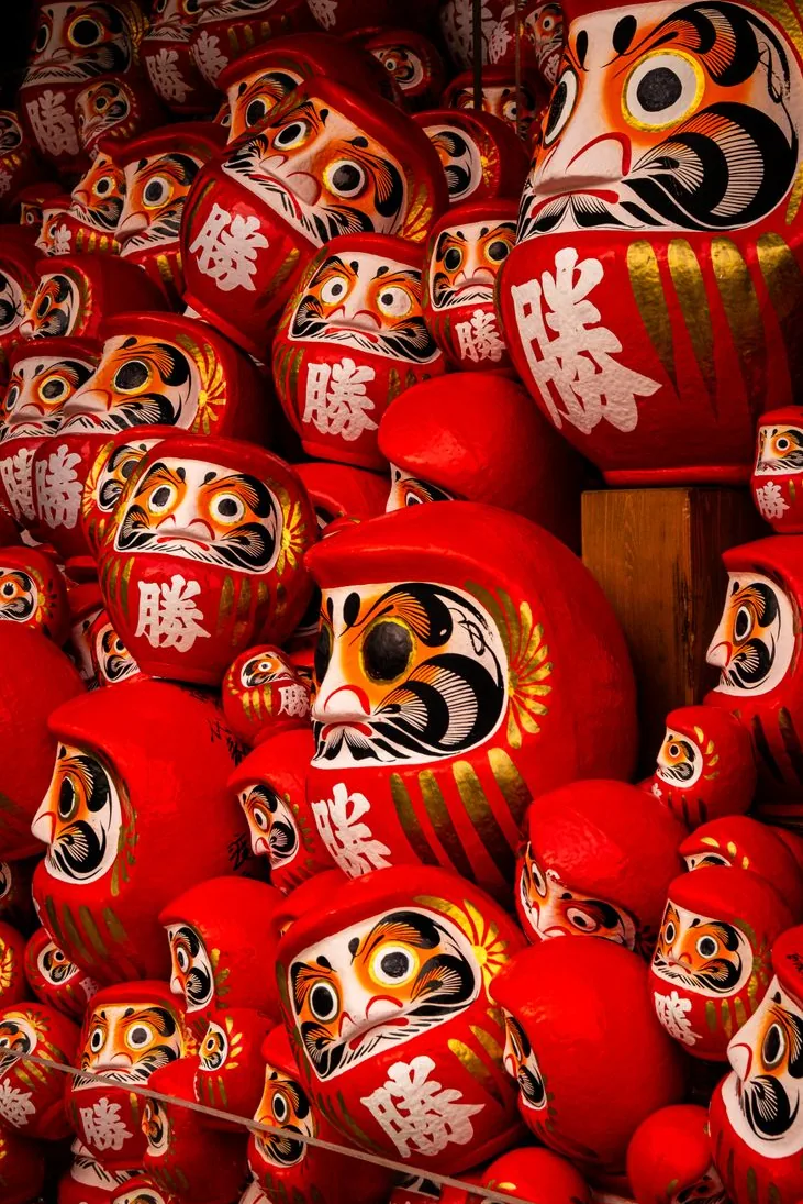 Rows of red daruma dolls
